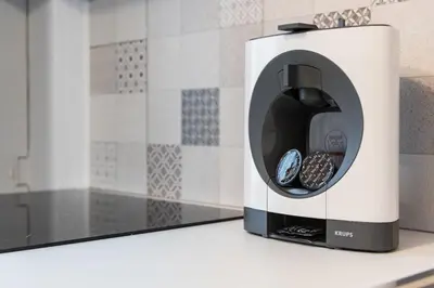 a toaster oven sitting on a counter with two cookies at GuestReady - Yazdah Flat 3 in Porto