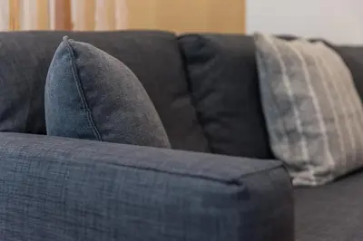 a blue couch with two pillows on it at GuestReady - Yazdah Flat 3 in Porto