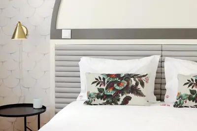 a bedroom with a bed with two pillows and a table at HM - Vagus Oporto House in Porto