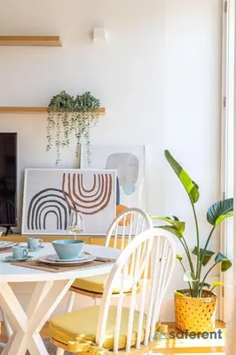 a dining room with a table with chairs and a plant at Flores - Delight Loft Porto - Next to Ribeira in Porto
