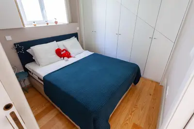a small bedroom with a red stuffed animal sitting on a bed at Oporto City View - Flora Garden in Porto