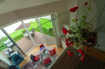 a vase of flowers on a table in a living room at Oporto City View - Flora Garden in Porto