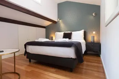 a bedroom with a large bed and a table at TMH Torrinha in Porto