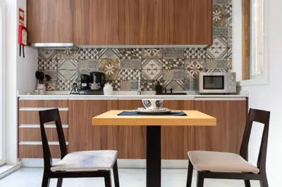 a kitchen with a wooden table and two chairs at TMH Torrinha in Porto