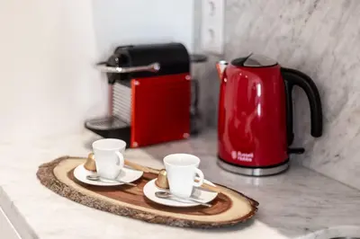 two coffee cups on a tray next to a toaster at Swimming Pool Luxury House 1 in Porto