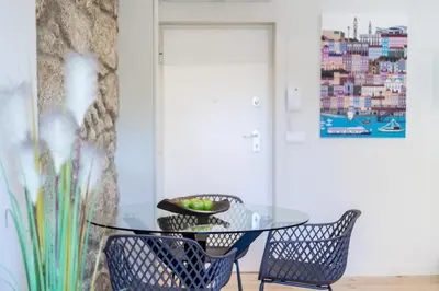 a glass table and two chairs in a room at Swimming Pool Luxury House 1 in Porto