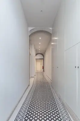 a hallway with white walls and a black and white tile floor at Swimming Pool Luxury House 1 in Porto