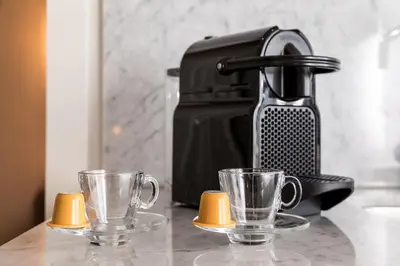 a coffee maker and two cups on a counter at Oporto Swimming Pool House in Porto