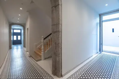 a hallway with a tile floor and a glass door at Oporto Swimming Pool House in Porto