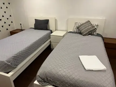 two twin beds in a room with one sidx sidx sidx sidx at Invicta House Gold in Porto
