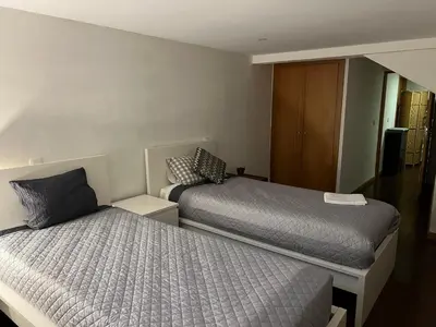 a bedroom with two beds and a cabinet at Invicta House Gold in Porto