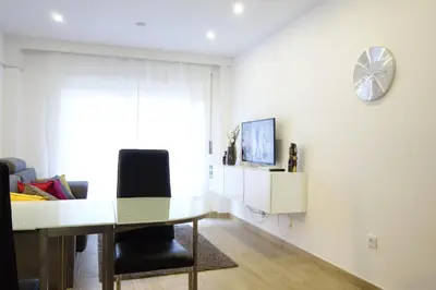 a dining room with a table and a clock on the wall at Porto River Sunset 1st in Vila Nova de Gaia