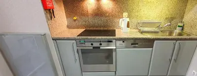 a small kitchen with a sink and a stove at VIVER D'AMOR Oporto Douro River Flat in Vila Nova de Gaia
