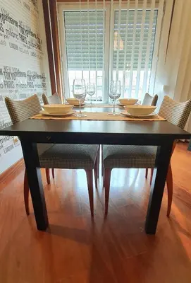 a dining room table with chairs and wine glasses at VIVER D'AMOR Oporto Douro River Flat in Vila Nova de Gaia