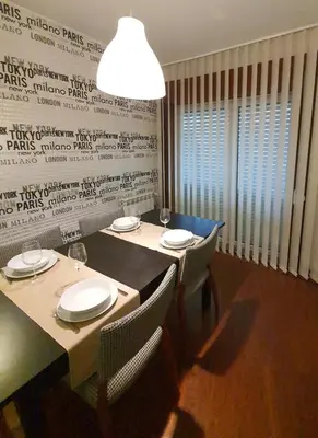 a dining room with a table with chairs and a light fixture at VIVER D'AMOR Oporto Douro River Flat in Vila Nova de Gaia