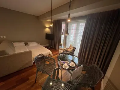 a bedroom with a bed and a table and chairs at New Oporto Apartments - São Bento in Porto