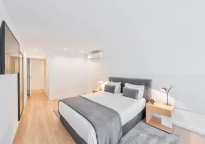 a bedroom with a large white bed in a room at Oporto Comfort Dom Hugo - Historic Apartments in Porto