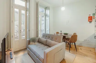 a living room with a couch and a table at Cozy Flat with Terrace by Hosty in Porto