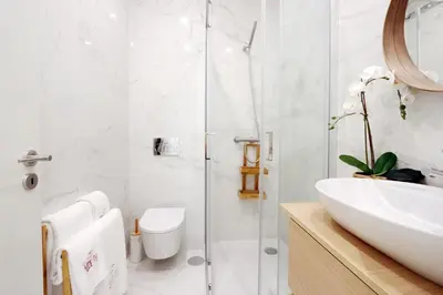 a bathroom with a glass shower and a sink at HM - Segredo do Porto in Porto