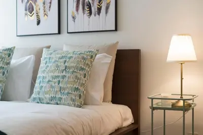 a bedroom with a bed with a pillow and a lamp at Rua de Camões in Porto