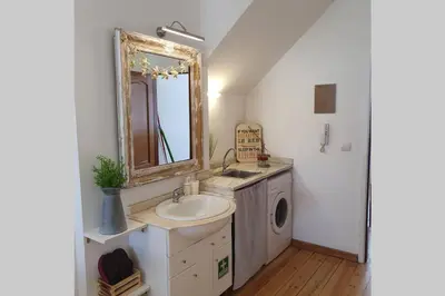a bathroom with a sink and a mirror at Charming Clérigos Studio in Porto