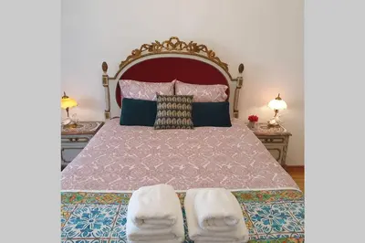 a bedroom with a large bed with two lamps at Charming Clérigos Studio in Porto
