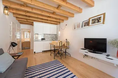 a living room with a couch and a tv and a table at PinPorto Downtown in Porto