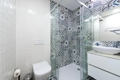a bathroom with a shower and a toilet and a sink at Rua do Freixo in Porto