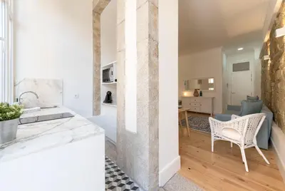 a kitchen and living room with a table and chairs at Rua do Freixo in Porto