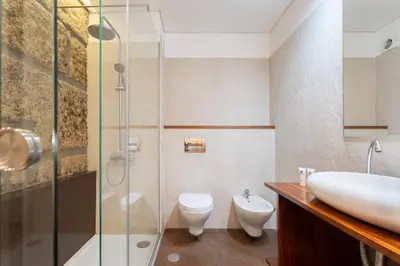 a bathroom with a sink and a toilet and a shower at Host Wise - Colorful Bright Flat with Balcony in Porto