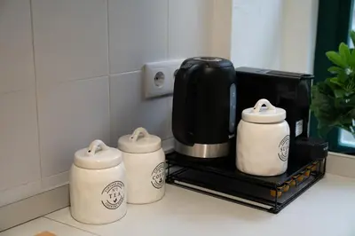 three coffee pots sitting on a counter in a kitchen at Clerigos Townhouse Porto by PCH in Porto