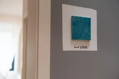 a picture on a wall with a blue object on it at Clerigos Townhouse Porto by PCH in Porto