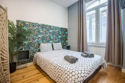 a bedroom with a bed with two towels on it at Guest H4U - Porto Fontainhas in Porto