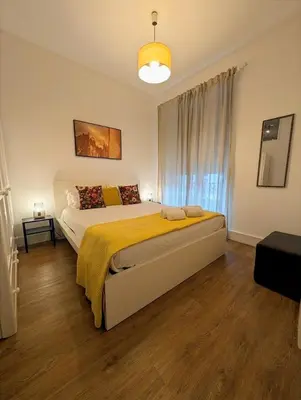a bedroom with a large bed with a yellow blanket at Beautiful Infante Apartment in Porto
