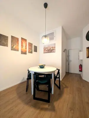 a table and chairs in a room with paintings at Beautiful Infante Apartment in Porto