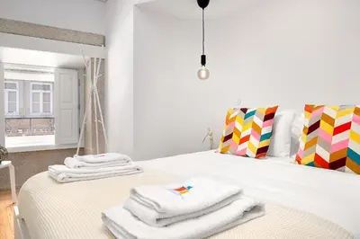 a bedroom with a bed with towels on it at Liiiving in Porto - Santa Catarina Boutique in Porto
