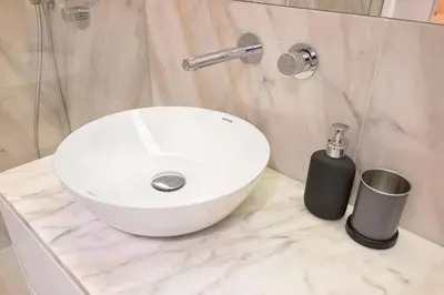a bathroom with a white sink and a soap dispenser at Liiiving in Porto - Santa Catarina Boutique in Porto
