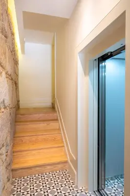 a hallway with a glass door and a tile floor at Liiiving in Porto - Santa Catarina Boutique in Porto