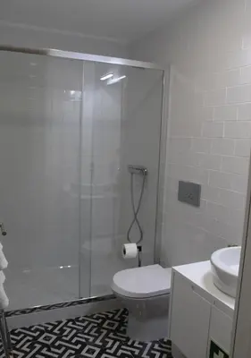 a bathroom with a shower and a toilet and a sink at Oporto Coliseum Studio in Porto