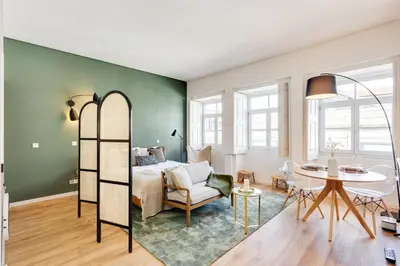 a living room with a bed and a table at DA'HOME - Boavista Green Studio in Porto