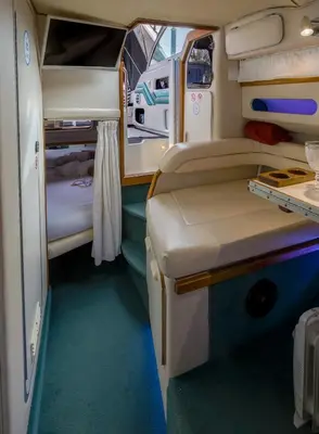 a small room with a bed and a table in it at SLEEPBOAT YACHT in Porto