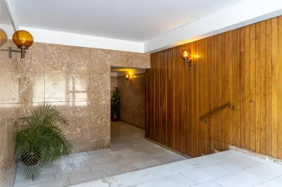 a hallway with a wooden wall and a plant at Porto Family Home by MP - Renovated in Porto