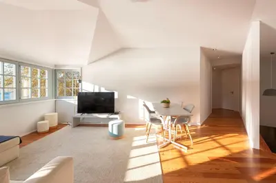 a living room with a table and a television at Duplex Douro River in Porto