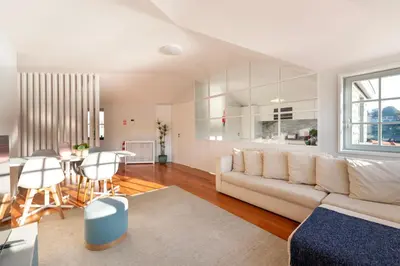 a living room with a white couch and a table at Duplex Douro River in Porto
