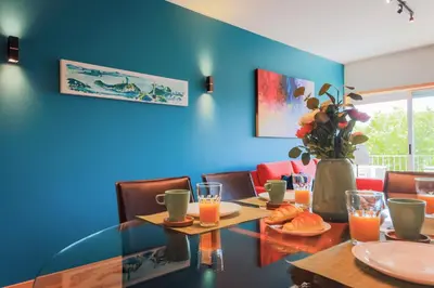 a dining room with a table and a blue wall at Porto Cathedral II in Porto