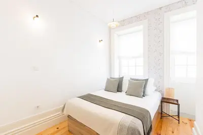 a living room with a couch and a tv at Bonfim Perfect Stays in Porto