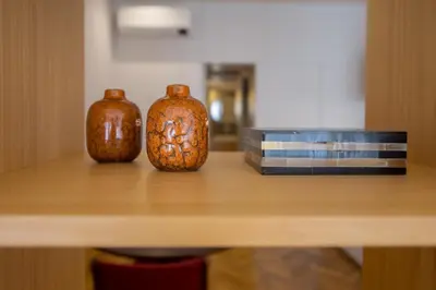 three vases sitting on top of a wooden table at Cedofeita Studio 176 - Studio in city center in Porto