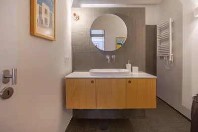 a bathroom with a sink and a mirror at Cedofeita Studio 176 - Studio in city center in Porto