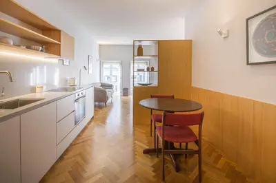 a kitchen with a table and chairs in a room at Cedofeita Studio 176 - Studio in city center in Porto