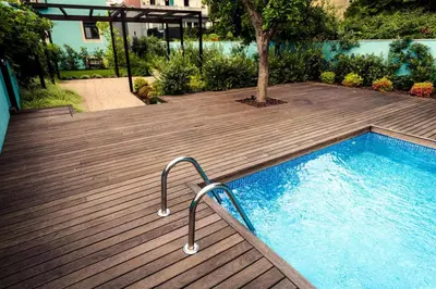 a wooden deck with a swimming pool and a tree at Swimming Pool Luxury House 2 in Porto
